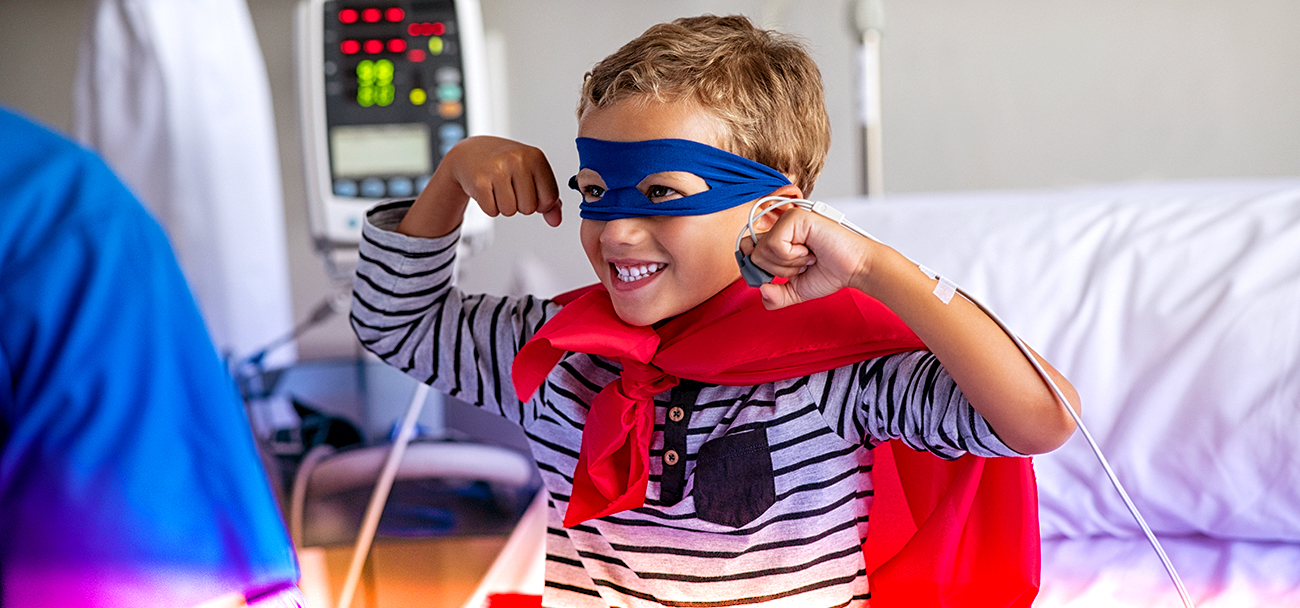 Cheerful,Strong,Little,Boy,Wearing,Blue,Eyeband,And,Red,Cape
